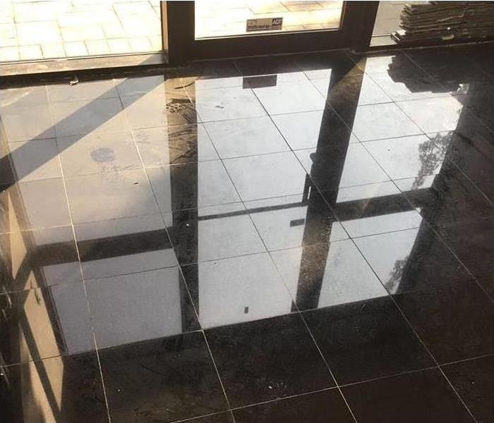 Flooded commercial lobby floor after winter storm