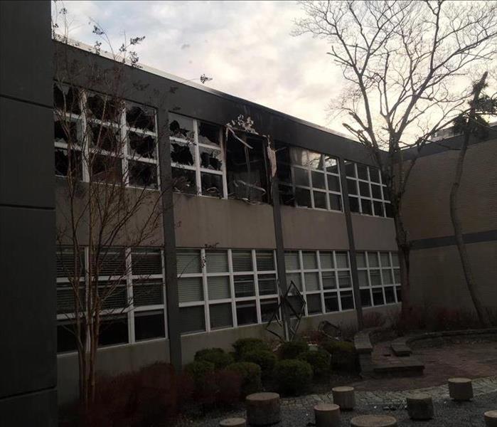 Fire damage to interior and exterior of school broken windows, soot and smoke damage